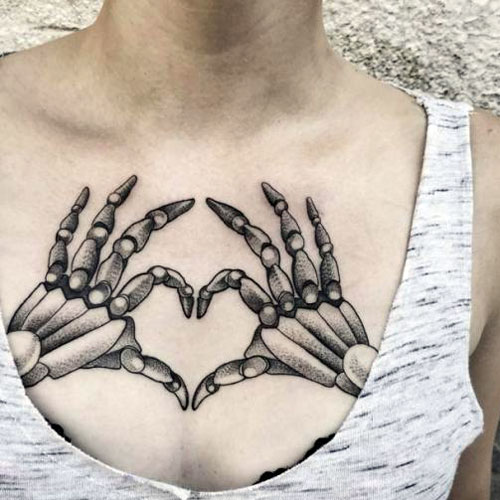 Skeleton Hand Holding Heart Tattoo Designs